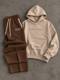 Beige hoodie and brown sweatpants set laid flat